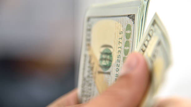 istock Usd dollar banknotes in hands businessman. 1288328124