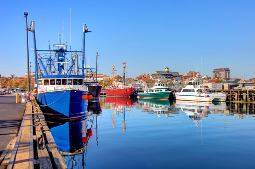 New Bedford Harbor and downtown skyline. New Bedford is America's #1 fishing port with a large fishing fleet. Also known as the The Whaling City because during the 19th century, the city was one of the most important whaling ports in the world.