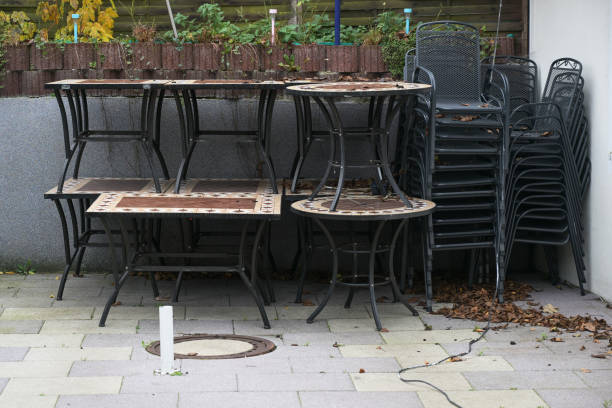 Stacked tables and chairs on the restaurant terrace during lockdown due to coronavirus pandemic