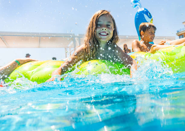 istock Kids floating on water in pool 1288330739