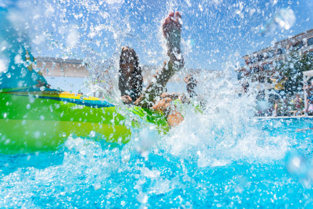 istock Playful girl floating on water in pool 1288330839