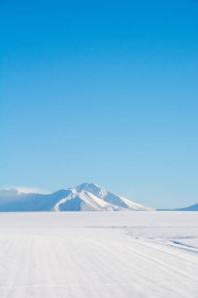 istock Snowfields and snowy mountains with a blue sky 1288332283