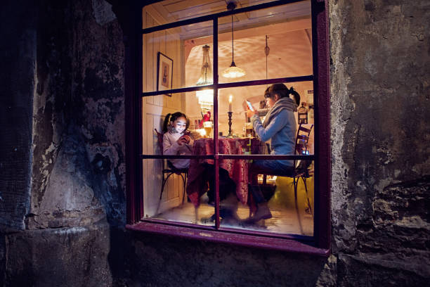 istock Girlfriends are sitting and texting in a cafe 1288332996