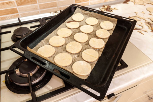 istock Rolling pin with dough on kitchen table. Preparing dough round tortillas for cookings to be baked. 1288333931