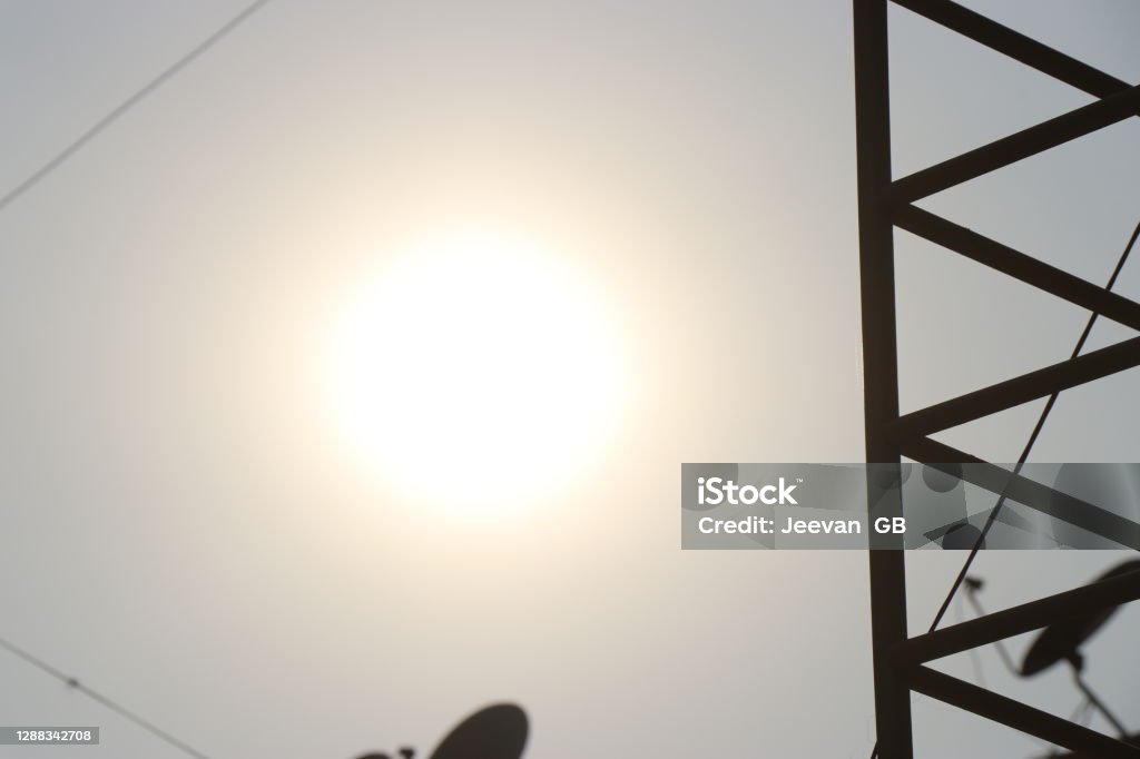 Electric pole with sun and sky background showing Energy concept Built Structure Stock Photo