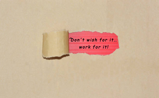 istock Motivational quote written on brown torn paper 1288349821