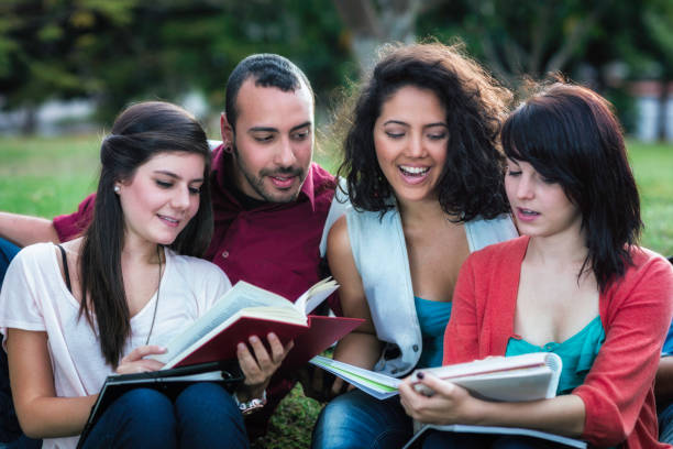 istock Multi-ethnic group of students reading books and sharing at university campus 1288356001