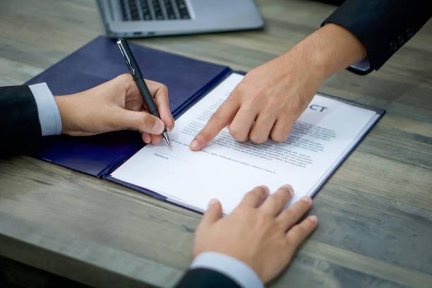 istock Human Resources staff point a finger to the vacant position for signing employment documents. 1288357150