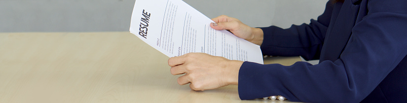HR manager checks the applicant's resume before start the interview. Close up