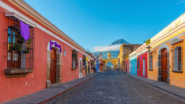 Antigua City, Guatemala Cityscape of Antigua city at sunrise with the Santa Catalina arch and Agua volcano with copy space, Guatemala. agua volcano photos stock pictures, royalty-free photos & images