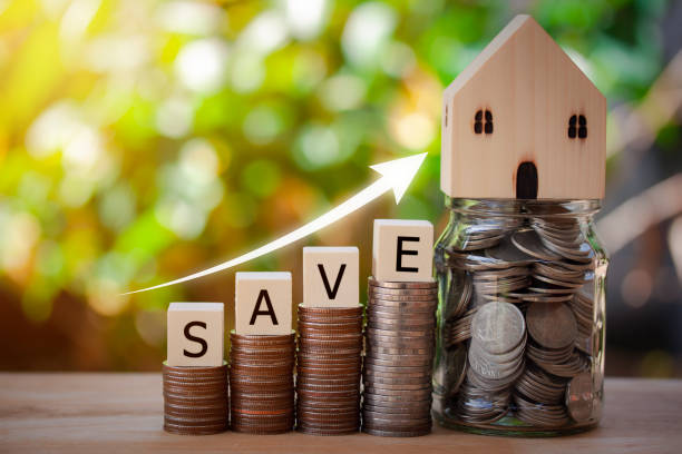 stacking coins for growing growth and house model on a jar full of coins. saving money concept, investment, mortgage, fund, finance and interest rate home to buying the future on bokeh background. - coin cheap jar currency imagens e fotografias de stock