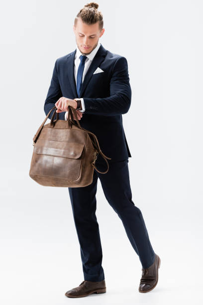 istock young businessman in suit with suitcase isolated on white 1288362340