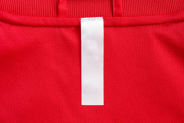 istock White blank clothes label on red jersey texture background 1288362399