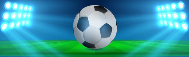 istock Realistic soccer ball on a green soccer lawn 1288363359