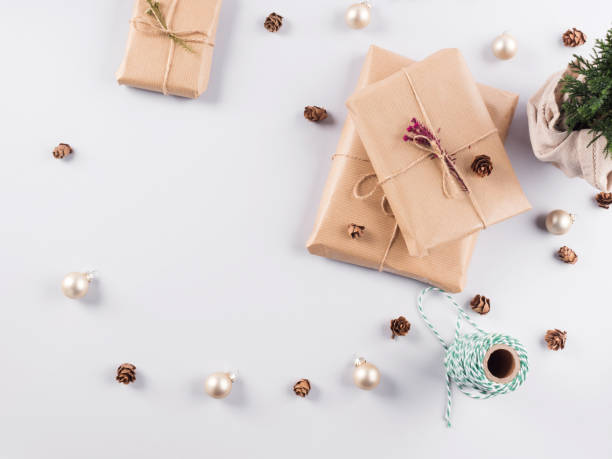 istock Xmas wrapped gifts stack and tree plant as gift 1288363431