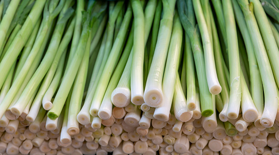Close-up leek background. fresh vegetables standing on the counter in the market place