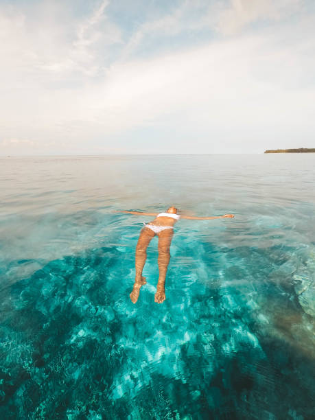 istock Woman floating on the water 1288366667