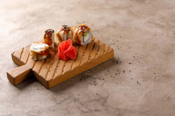 istock Appetizing rolls on a textured background. Japanese food concept. Close-up. Copy space. 1288368493