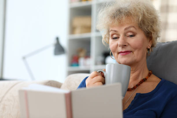 istock Blonde senior lady on sofa 1288369349
