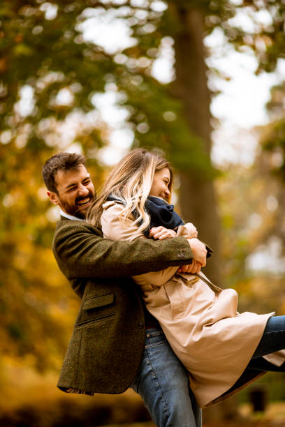istock Young couple having fun in the autumn park 1288373511
