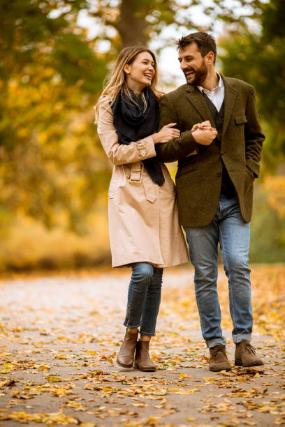 istock Young couple walking in the autumn park 1288373513