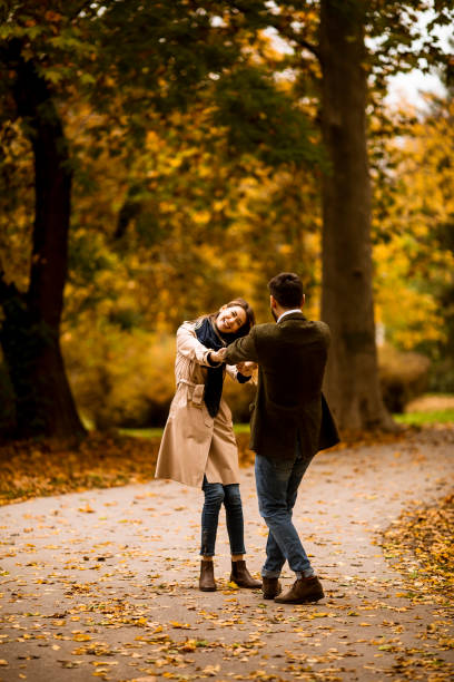 istock Young couple having fun in the autumn park 1288373518