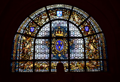 Paris, France. August 12, 2019. Basilique Saint-Denis, window close-up with coat of arms from French Royal House of Bourbon.