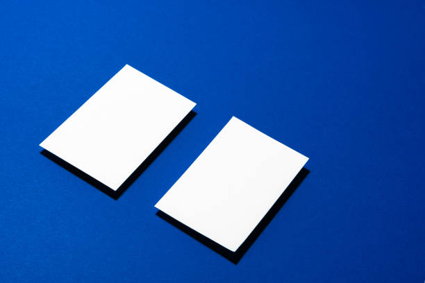 istock Two stacks of blank businesscards on blue background 1288374880