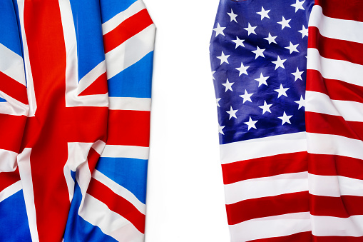 Flags of Great Britain and USA folded together close up