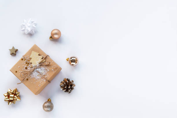 istock Christmas gift in a box and baubles on white background with copy space 1288376936