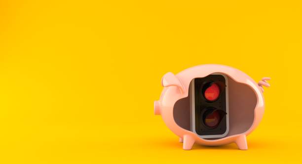 istock Red traffic light inside piggy bank 1288377953
