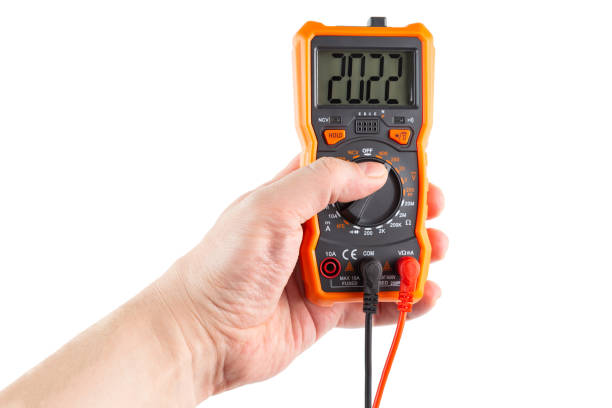 istock digit 2022 on lcd screen of digital electrical multimeter in left hand, isolated on white background 1288378880