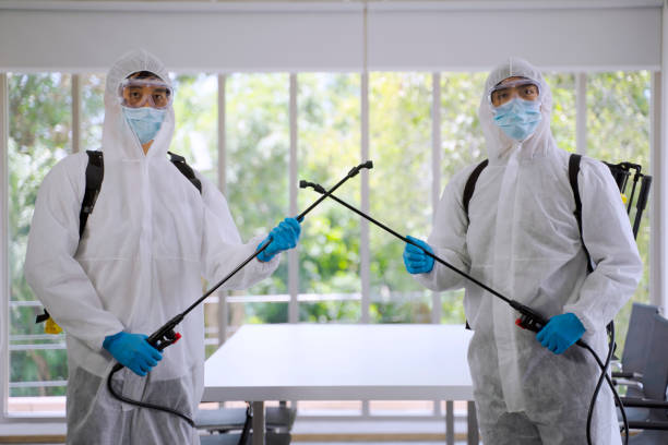 istock Staff spray germicide at the building. 1288380034