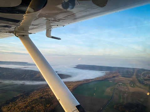Beautiful aerial view of countryside during sunset from a Cessna Plane window