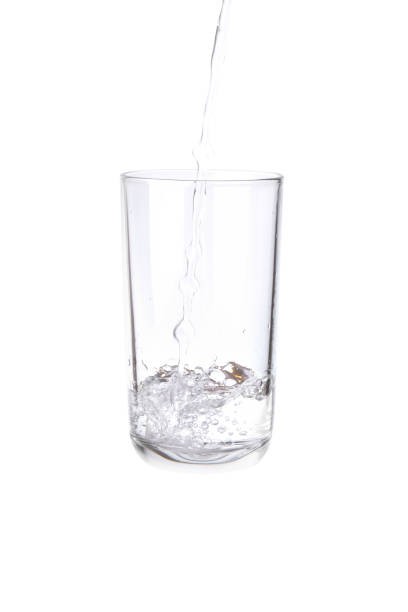 istock Pouring water into a separate glass on a white background. Clean drinking water concept 1288380842