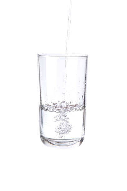 istock Pouring water into a separate glass on a white background. Clean drinking water concept 1288380847