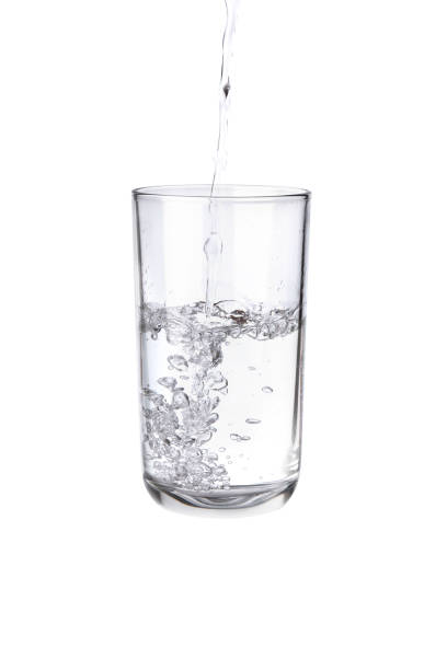 istock Pouring water into a separate glass on a white background. Clean drinking water concept 1288380854