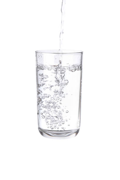 istock Pouring water into a separate glass on a white background. Clean drinking water concept 1288380896