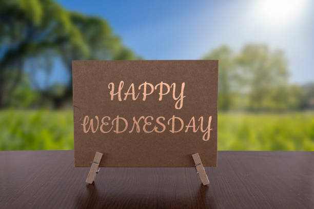 Happy Wednesday card on the table with sunny green forest background. Happy Wednesday card on the table with sunny green forest background. wednesday morning stock pictures, royalty-free photos & images