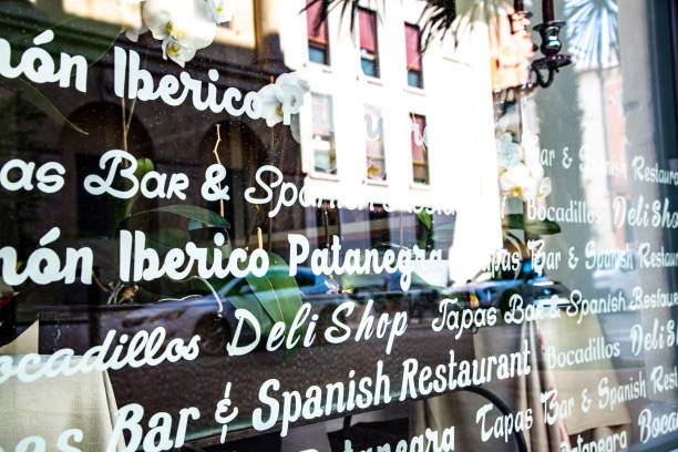 Verona, Veneto/Italy - 18.08.2020: A shop window of a Spanish restaurant in Italy with white lettering of all possible offers and different fonts