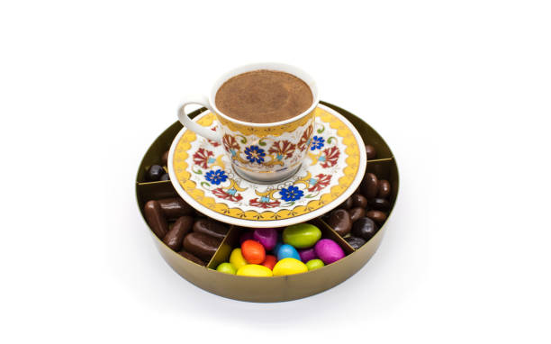 istock Turkish coffee with chocolate around it on white. Turkish cup of black coffee. colored chocolates 1288381601
