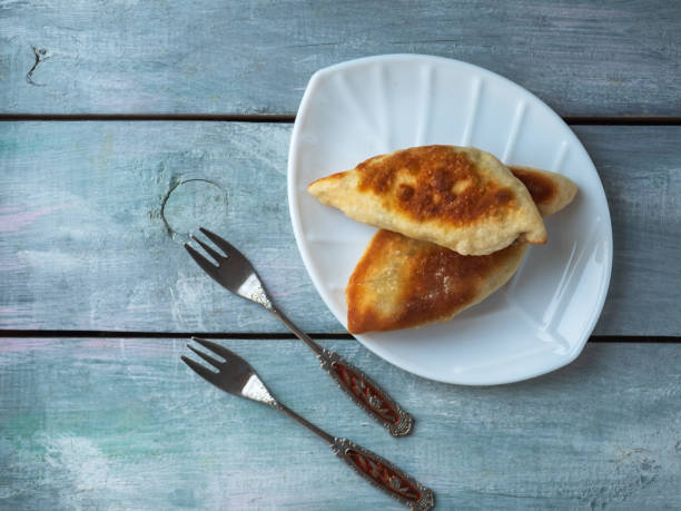 istock Fast breakfast with pies on white plate and vintage forks 1288383365