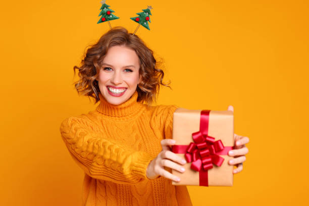 istock Glad young female with Christmas gift 1288383868