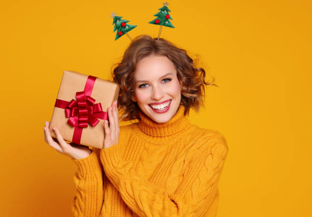 istock Glad young female with Christmas gift 1288383907