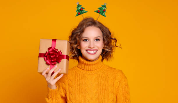 istock Glad young female with Christmas gift 1288383967