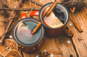 Mulled wine background. A hot winter Christmas drink based on red wine, spices and citrus fruits.