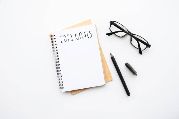 istock Notebook with 2021 goals text on it to apply new year resolutions and plan. 1288384755
