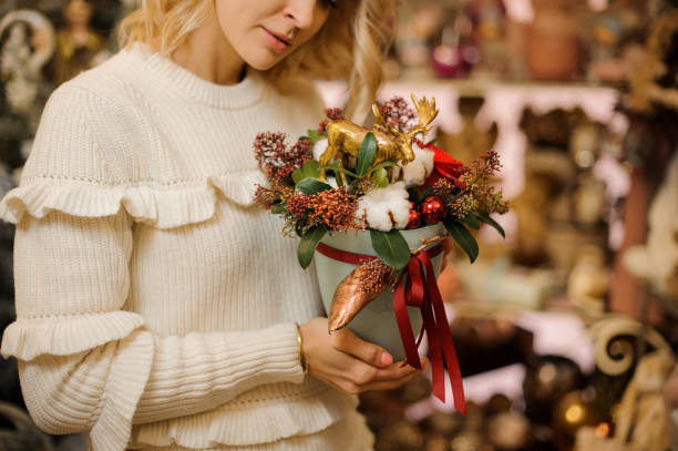 istock beautiful creative composition decorated with shiny Christmas decorations in female hands 1288384869