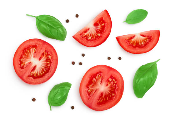 istock Tomato slices with basil and peppercorns isolated on white background. Clipping path and full depth of field. Top view. Flat lay 1288384951