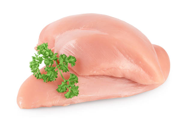 istock Fresh chicken fillet with parsley isolated on white background with clipping path and full depth of field. 1288385559